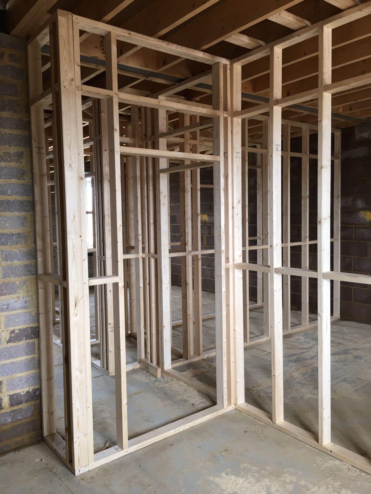 Timber stud partition frame with door opening formed in a residential new-build interior
