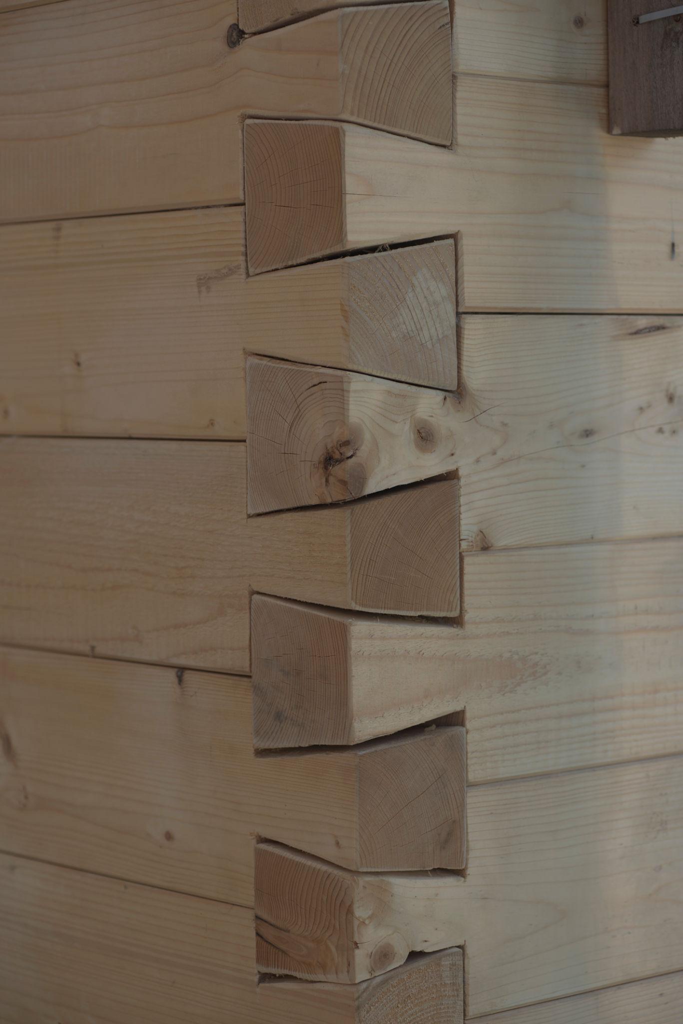 Close-up of a precision dovetail corner joint in structural timber carpentry