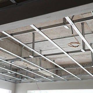Suspended ceiling metal grid framework — tracks installed before tiles are dropped in