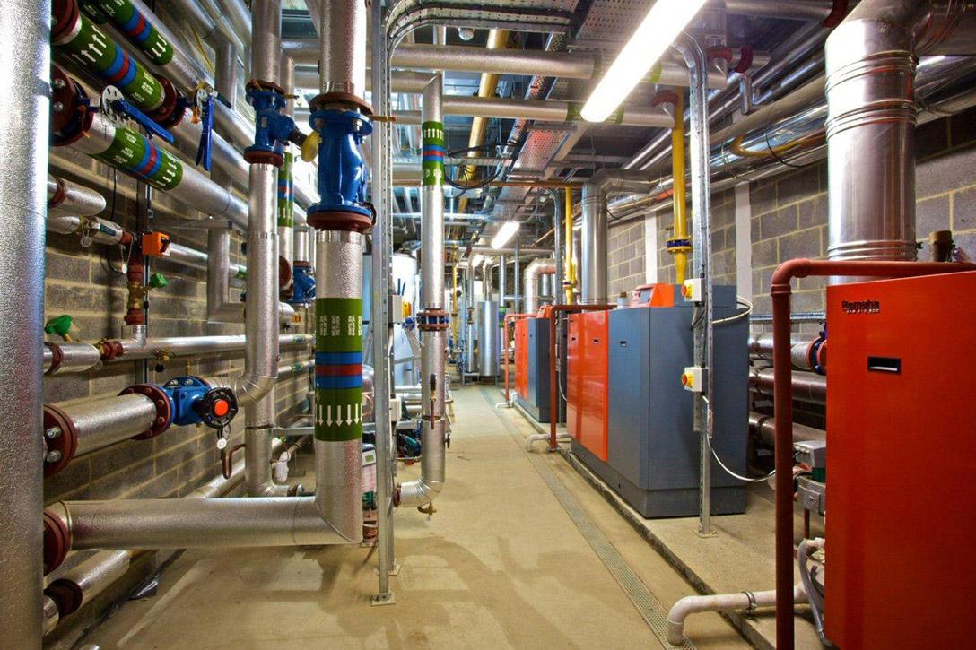 Commercial boiler room — complex pipework installation with large vessels and boilers
