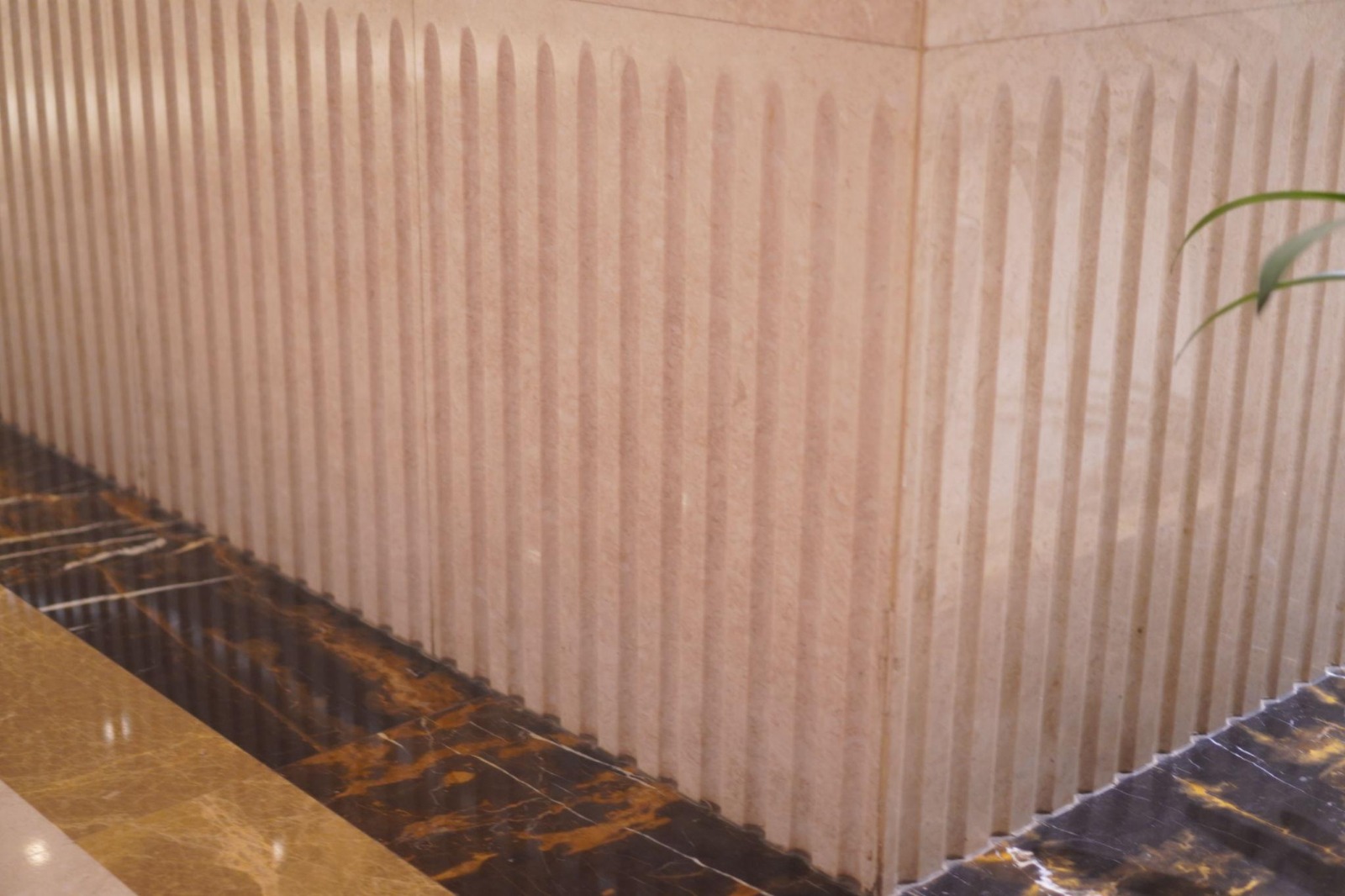 Decorative fluted travertine wall tiles with dark marble slab floor — high-end tiling by Takeair Ltd London