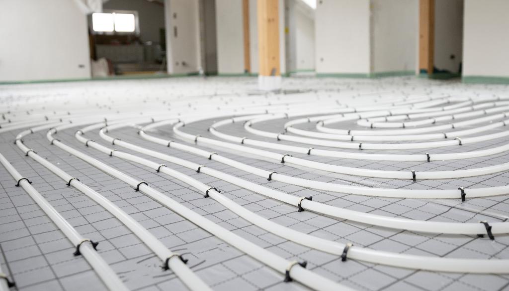 White underfloor heating pipes on gridded insulation board — clean and precise installation by Takeair Ltd London